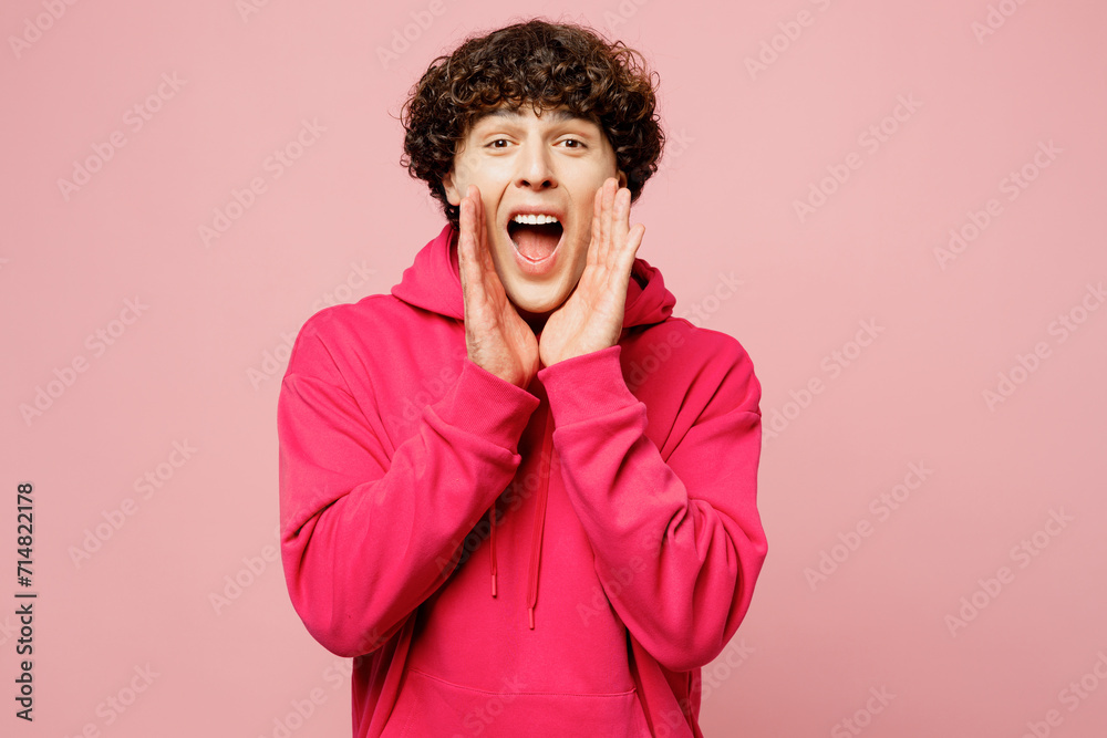 Young Caucasian man he wears hoody casual clothes scream sharing hot news about sales discount with hands near mouth isolated on plain pastel light pink background studio portrait. Lifestyle concept. Young Caucasian man he wears hoody casual clothes scream sharing hot news about sales discount with hands near mouth isolated on plain pastel light pink background studio portrait. Lifestyle concept.