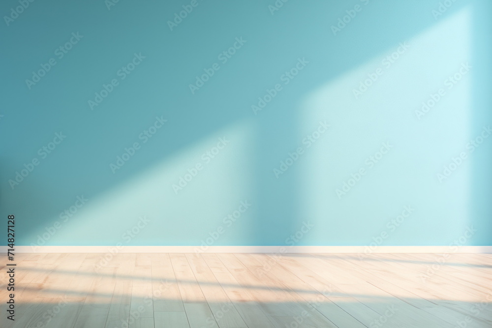 Empty room with blue wall and wooden floor.