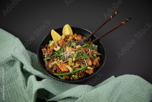 baked marinated chicken breast with soba noodles, celery, beans and parsley photo