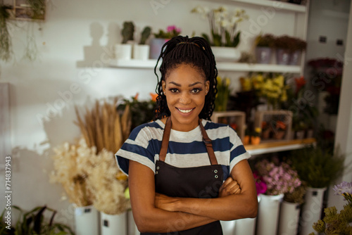 Portrait of a young african american female florist in flower shop photo