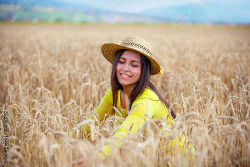 young girl in a hat in a wheat field