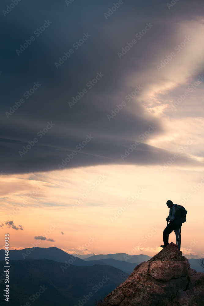 Fototapeta premium silhouette of a person on the top of the mountain