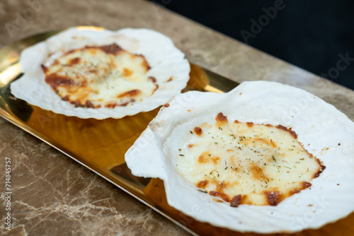 Baked Scallop with cheese served on plate