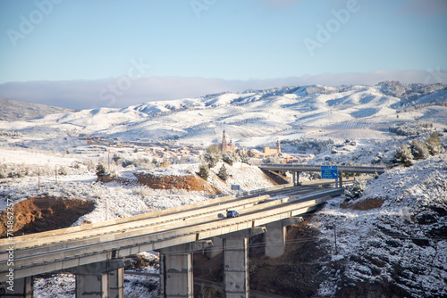 Snow. Winter landscape covered in a white blanket of snow covering mountains and roads. Trees with snow. Clear day. White blanket due to a storm with heavy snowfall. In Spain. January. 2024.