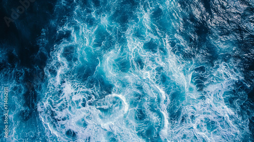 waves in the open ocean, capturing the vast energy spread across the water, varying sizes of waves, realistic blue hues of the sea, under clear skies