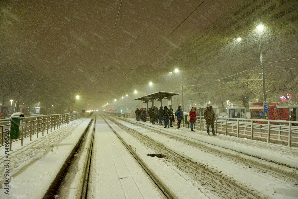 People in traffic through snow in Bucharest, Romania, January 20, 2024