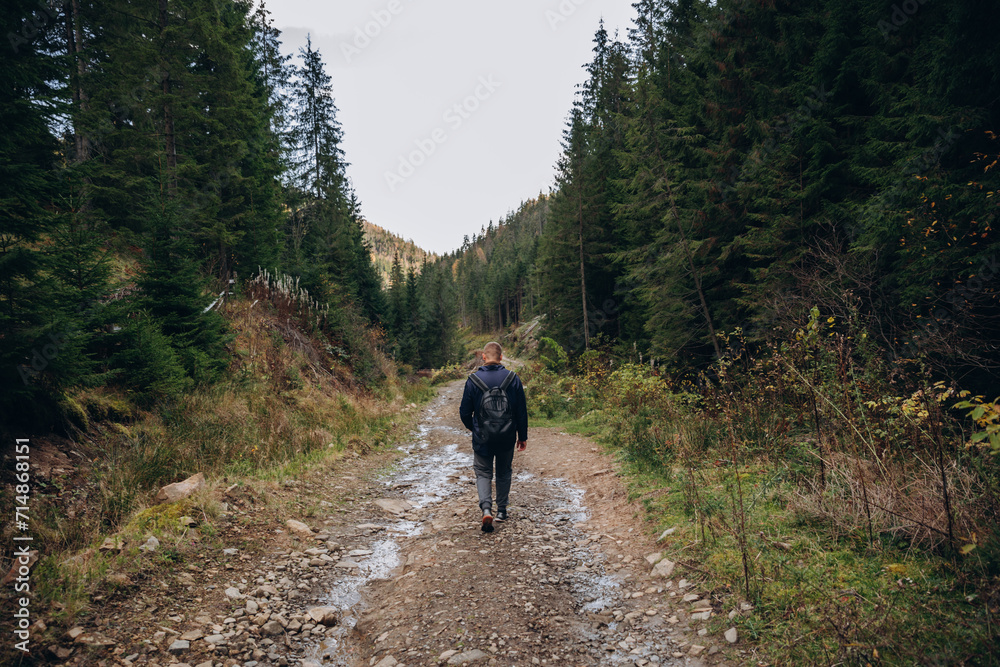 Fototapeta premium Going the distance. Shot of a young man enjoying a hike through the mountains. a handsome man with an athletic build is traveling in the mountains. landscape 