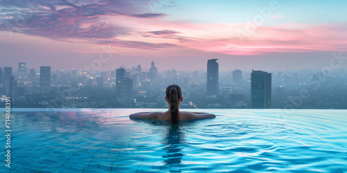 Woman relaxing in infinity pool and admiring cityscape and skyscrapers.