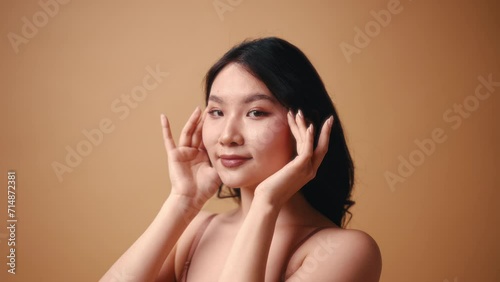 Wallpaper Mural Portrait of a young Asian woman in beige lingerie posing on a beige background. The concept of skin care, cosmetology and spa treatments. Torontodigital.ca