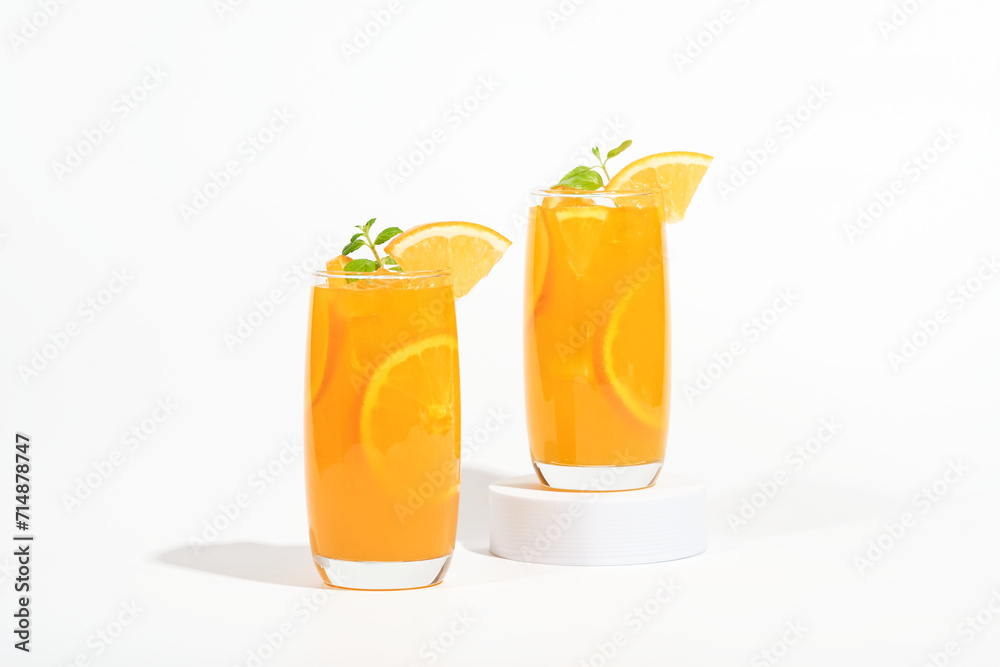 Glass of 100% Orange juice with orange slices fruits isolated on white background. cooling beverage summer drink Glass of 100% Orange juice with orange slices fruits isolated on white background. cooling beverage summer drink