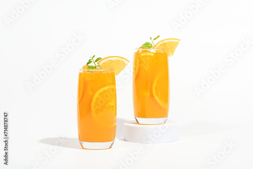 Glass of 100% Orange juice with orange slices fruits isolated on white background. cooling beverage summer drink