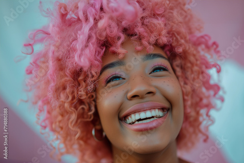 A young woman with pink hair smiling, radiating joy and confidence. young laughing African american woman with pastel pink hair, blue eyes, peace gestures funny facial expressions