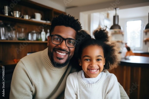 Smiling portrait of a young father and daughter