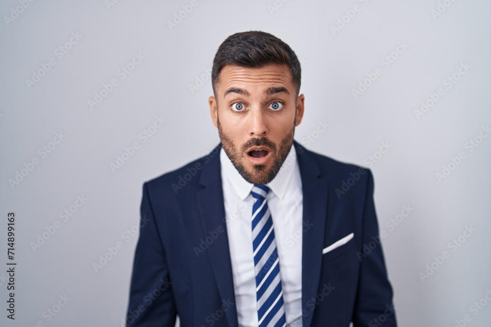 Handsome hispanic man wearing suit and tie afraid and shocked with surprise and amazed expression, fear and excited face. Handsome hispanic man wearing suit and tie afraid and shocked with surprise and amazed expression, fear and excited face.