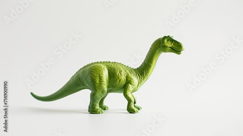 A plastic toy dinosaur isolated on a white background with copy space