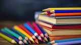 Textbooks and color pencils on the school desk - close-up