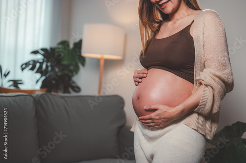 mother, family, maternity, pregnant, woman, pregnancy, baby, motherhood, love, happiness. pregnancy, motherhood, people, close up of happy pregnant woman with big belly near stand sofa and smiling. Free Download mother, family, maternity, pregnant, woman, pregnancy, baby, motherhood, love, happiness. pregnancy, motherhood, people, close up of happy pregnant woman with big belly near stand sofa and smiling. - GFXLoad