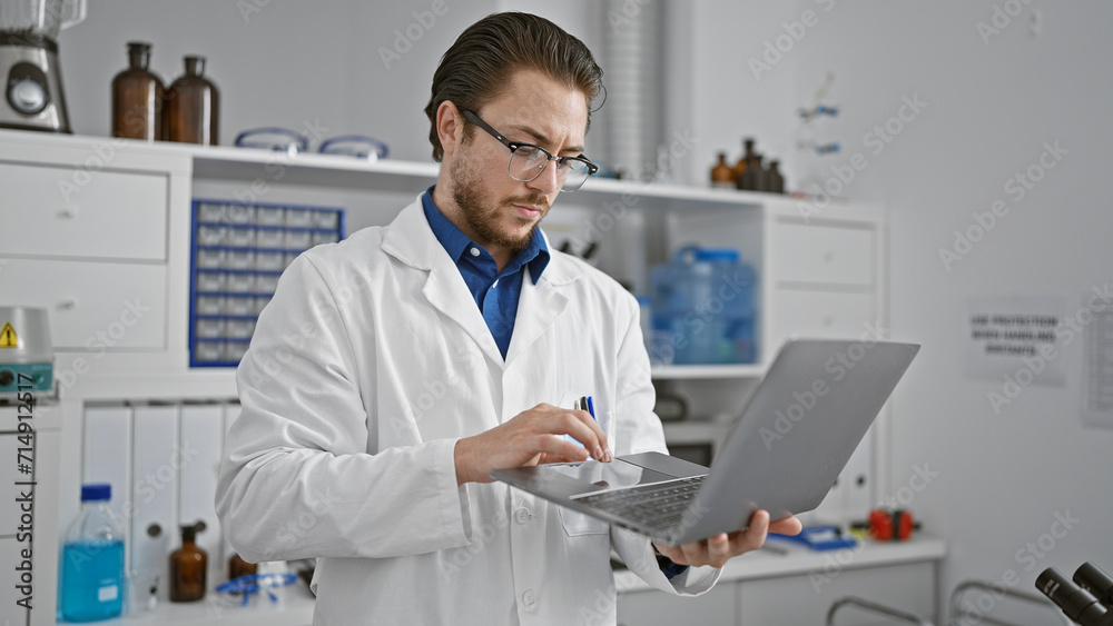 Young hispanic man scientist using laptop at laboratory Young hispanic man scientist using laptop at laboratory
