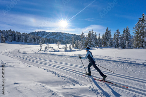 nice and active senior woman cross-country skiing in the  Hochhaedrich area of Bregenz Forest in Vorarlberg, Austria

