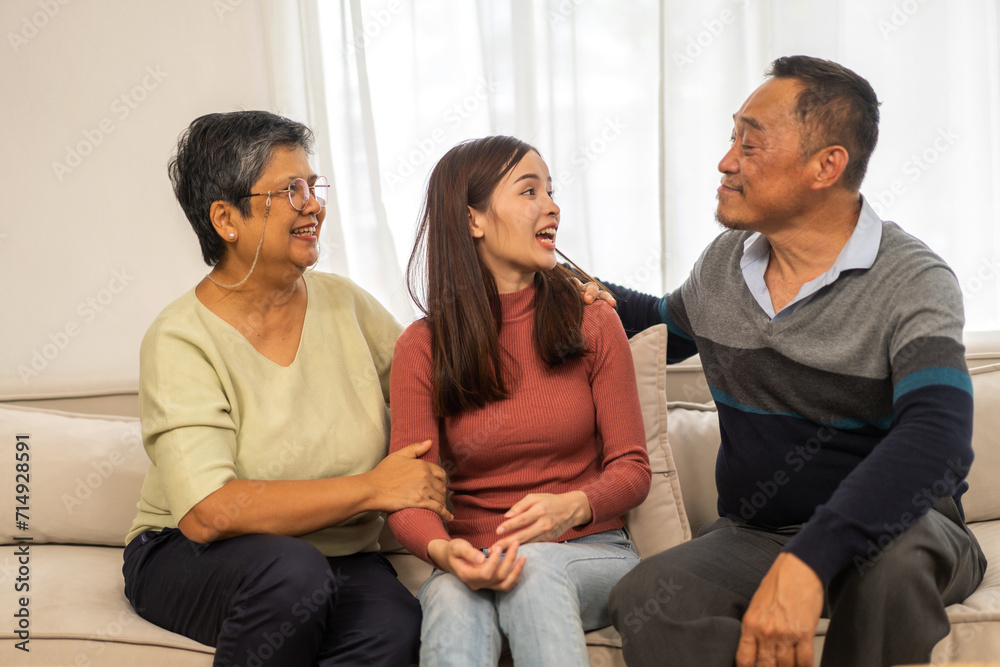 Portrait enjoy happy smiling love asian family.Senior mature father hug with elderly mother and young adult woman play laughing and having fun together at home.insurance concept Portrait enjoy happy smiling love asian family.Senior mature father hug with elderly mother and young adult woman play laughing and having fun together at home.insurance concept