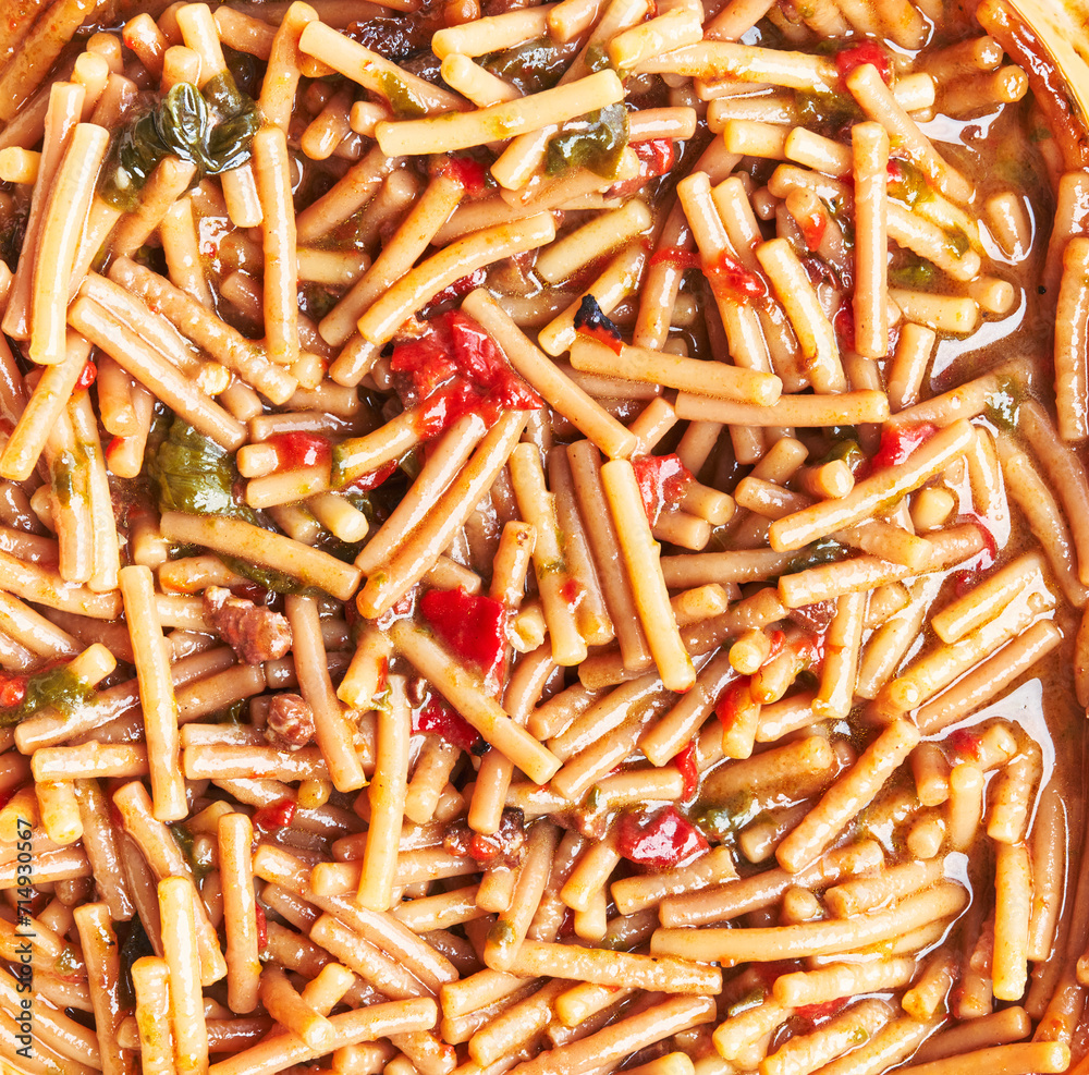 Close-up of spanish fideua with pasta noodles, seafood, tomato and spices. Close-up of spanish fideua with pasta noodles, seafood, tomato and spices.