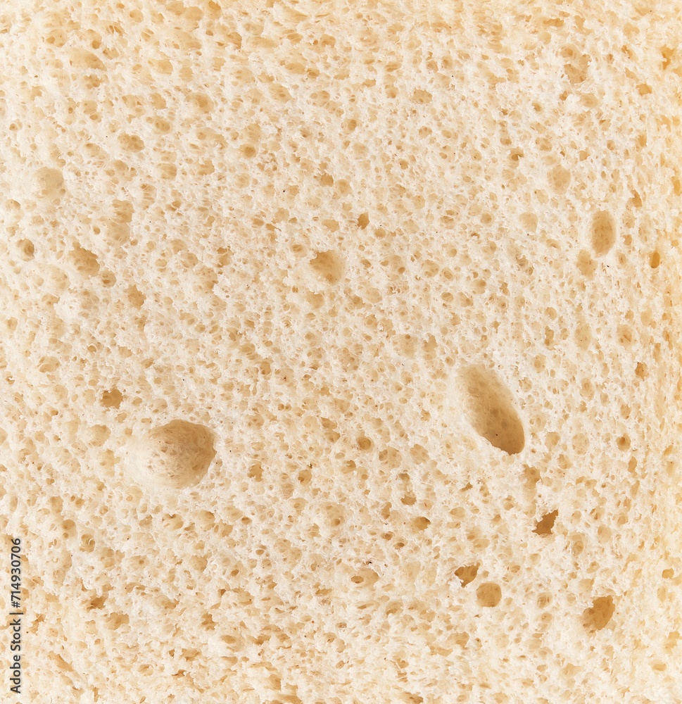 Close-up view of sliced bread highlighting its texture and porous surface ideal for food and bakery contexts.