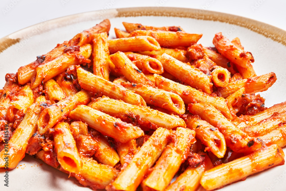 Delicious plate of italian macaroni with tomato sauce over isolated white background Delicious plate of italian macaroni with tomato sauce over isolated white background