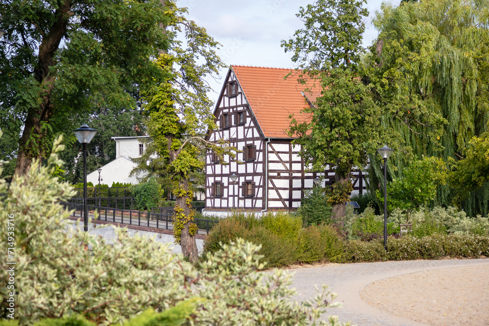 
A beautiful medieval building with a red tiled roof among green trees
