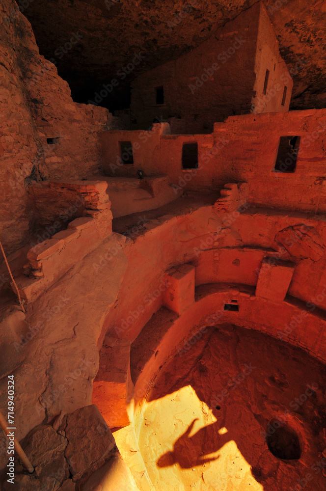 Shadow of a tourist on a kiva at the Cliff Palace ruins, the largest