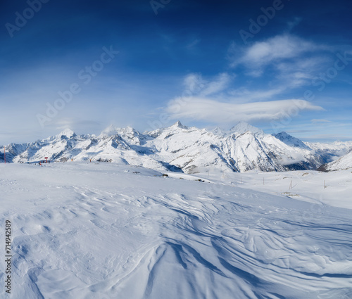 Winter mountain landscape. Wallpaper or background. Cold weather and frost. A place for skiing. Ski resort. High rocks and snow. View of mountains. © biletskiyevgeniy.com