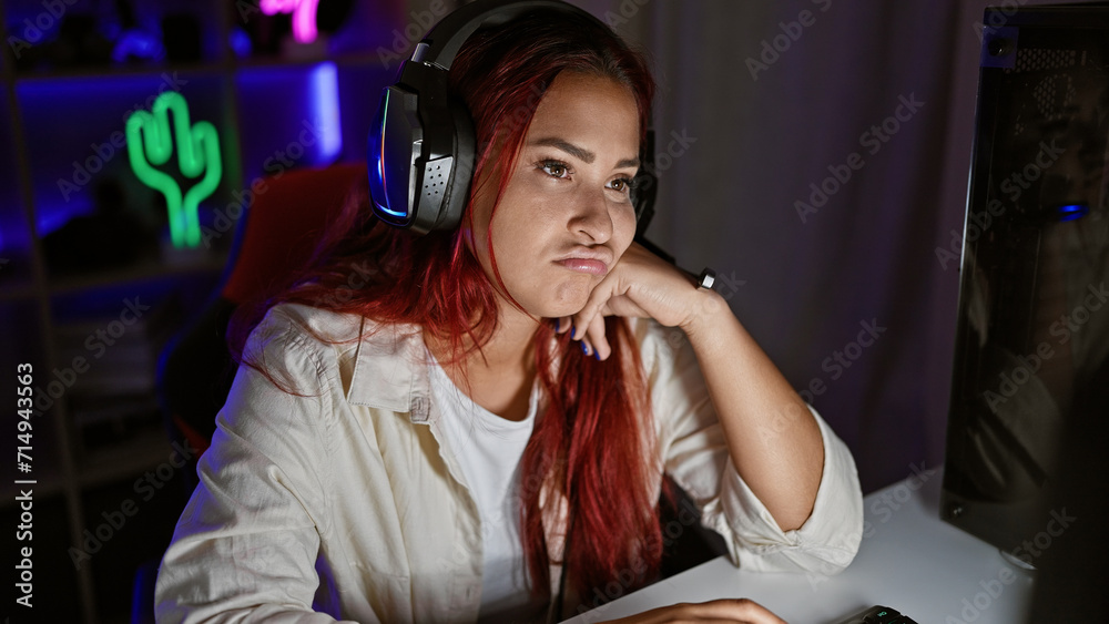 Heartbroken young redhead streamer woman, virtual gaming ends in sadness amidst the shadows of her dark gaming room Heartbroken young redhead streamer woman, virtual gaming ends in sadness amidst the shadows of her dark gaming room