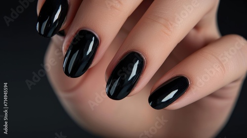 Photos of the design of black nails on the hands, advertising the color of the nails