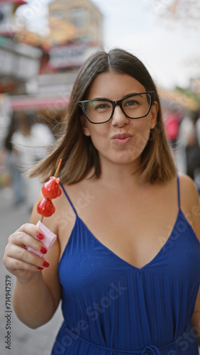 Photography Stunning hispanic woman savors yummy japanese strawberry candy on nakamise stree