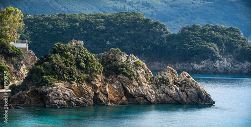 panoramic view of Rocky coastline covered by trees. Rocky coastline in amazing blue Ionian Corfu island in Greece.