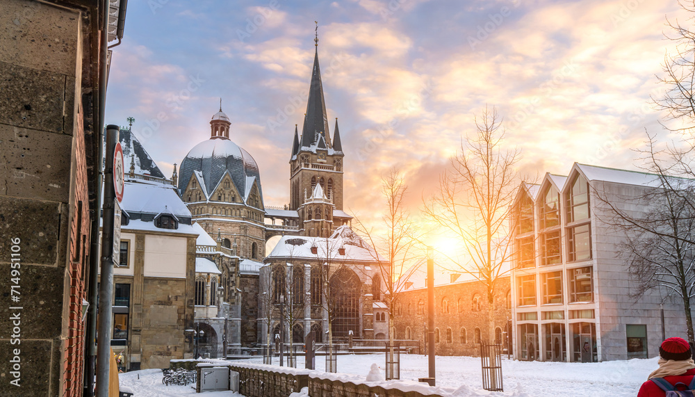 The famous Huge gothic cathedral of The Emperor Karl in Aachen Germany during winter season with snow at Katschhof against blue sky and sunshine background