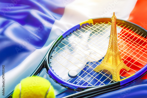 Tennis. Sport composition with yellow tennis ball, souvenir of eiffel tower and racket on french flag background. Concept of competitions, tournaments and sports