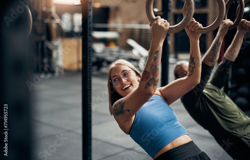 Smiling woman working out on rings during a gym exercise class photo