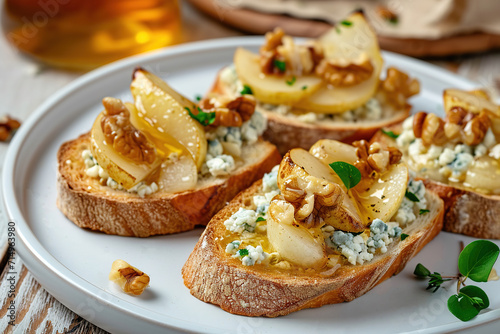 Appetizer bruschetta with pear, honey, walnut and blue cheese on plate