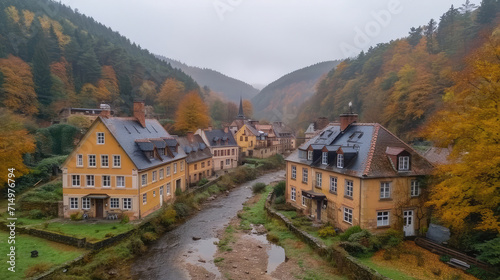 Drone view of a quaint village with autumn foliage.