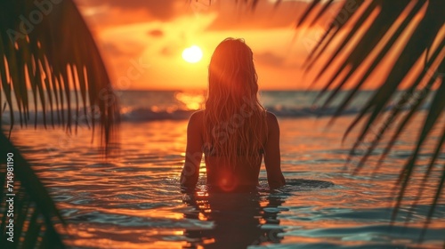 Silhouette of girl at beach dancing in water against sunrise background  beautiful sunrise color pallete  bokeh  palm trees