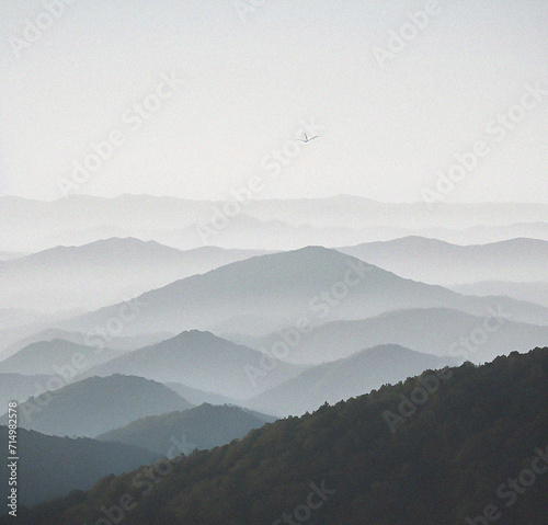 Mountains in the fog.  Beautiful background with empty copy space. Mountain peak with clouds. Minimalist backdrop. Nature, success, travel, holiday concept
