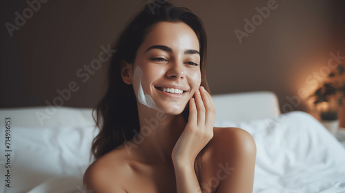 Caucasian woman taking care of her skin in the bedroom. photo