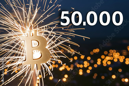 Bitcoin crypto symbol with Fireworks in the sky, celebrating the landmark price of 50000 USD. BTC hits fifty thousand, cryptocurrency market value forecast. photo