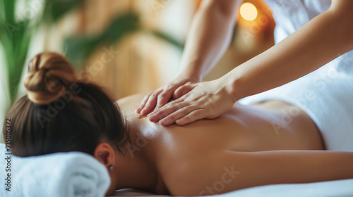 A woman enjoys a relaxing back massage at a spa to relieve tension and promote ultimate relaxation.