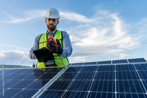 engineer technician checking output voltage level of inverter, electrician measuring power on solar panels