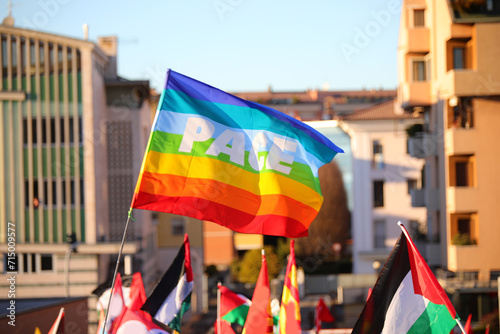 peace flag and other flags, including the Palestinian one, with the word PACE in Italian flying during the demonstration photo