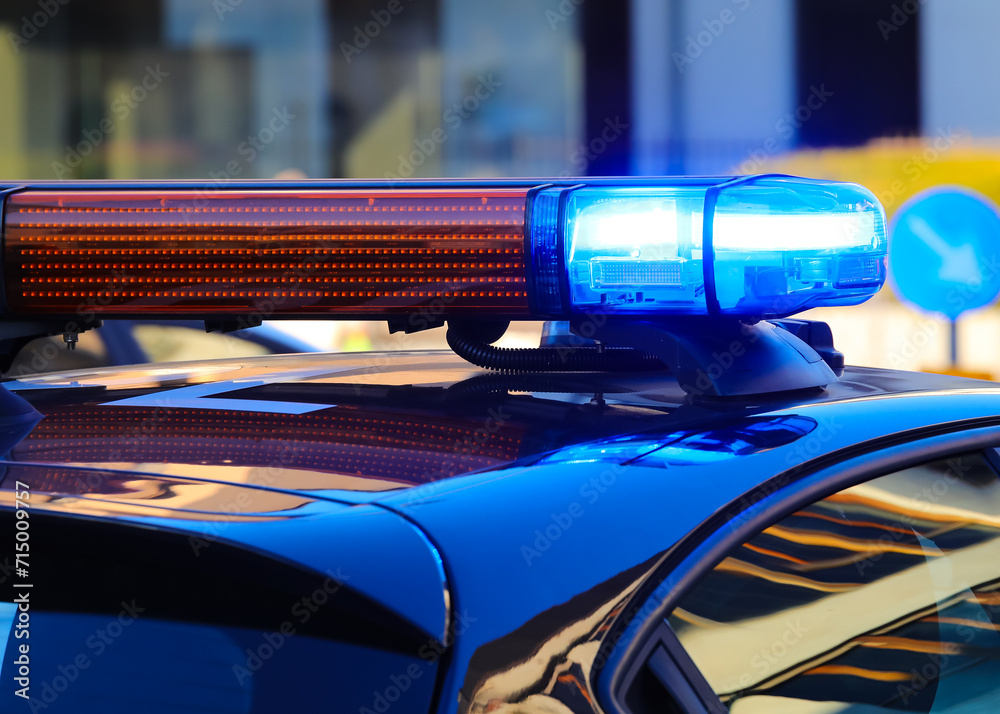 blue flashing siren on police car during control in the city streets