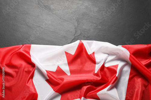 Flag of Canada on black background, top view. Space for text