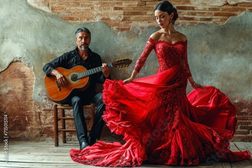 Flamenco woman moving in red dress and Spanish guitar player photo