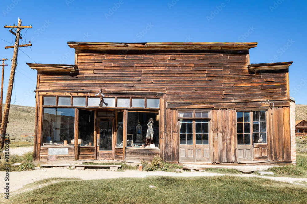 Brodie Ghost Town abandoned Mercantile General Store in the arid desert environment of California with empty street and no people with a clear cloudless blue sky.